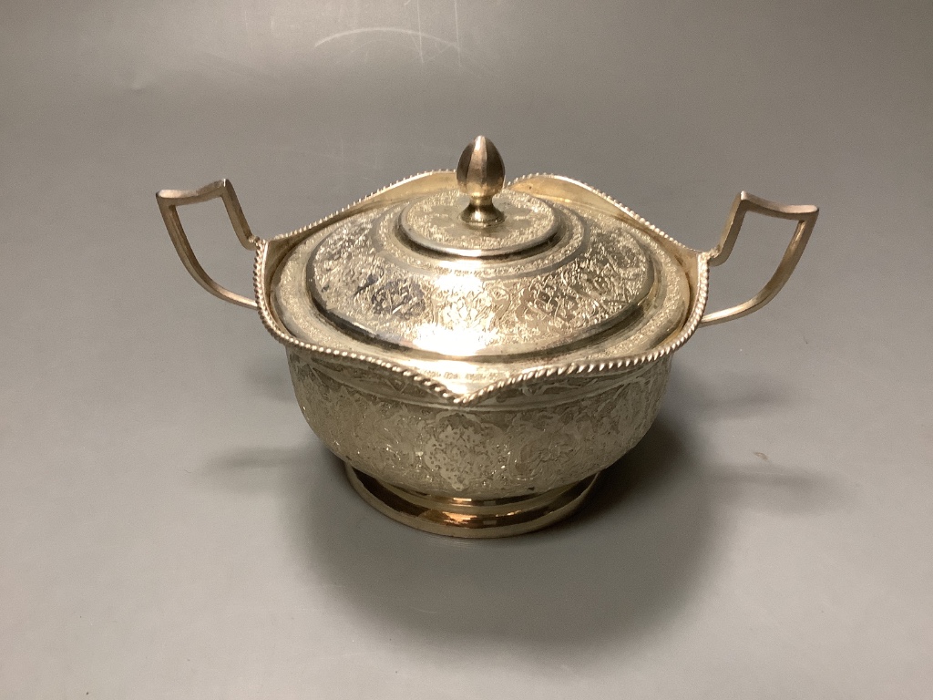 A Persian white metal sugar bowl and cover and five matching tea glass holders